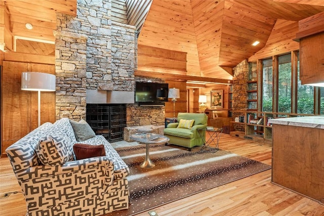 749 Stillmont Cir, Cashiers, NC 28717 - living area featuring lofted ceiling, wood finished floors, a fireplace, wooden walls, and wood ceiling