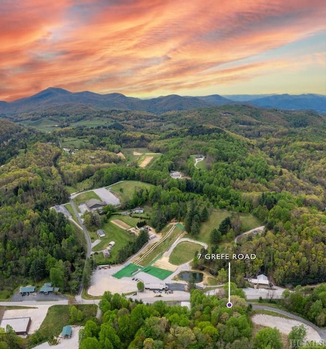 aerial view at dusk featuring a mountain view