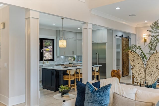 227 Sherwood Forest Rd, Highlands, NC 28741 - dining space with decorative columns, a barn door, light wood finished floors, recessed lighting, and ornamental molding