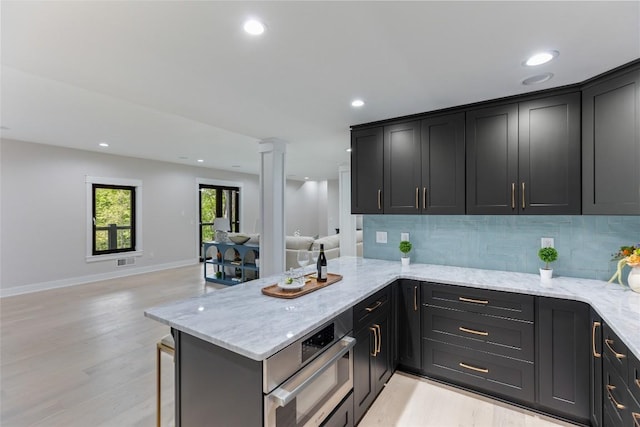 227 Sherwood Forest Rd, Highlands, NC 28741 - kitchen with open floor plan, ornate columns, backsplash, oven, and recessed lighting