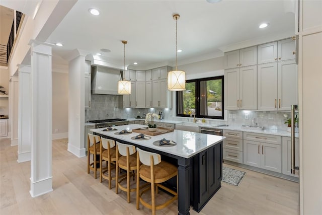 227 Sherwood Forest Rd, Highlands, NC 28741 - kitchen featuring decorative columns, a sink, a breakfast bar, backsplash, and a kitchen island