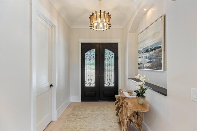 227 Sherwood Forest Rd, Highlands, NC 28741 - entrance foyer featuring a chandelier, french doors, baseboards, and crown molding