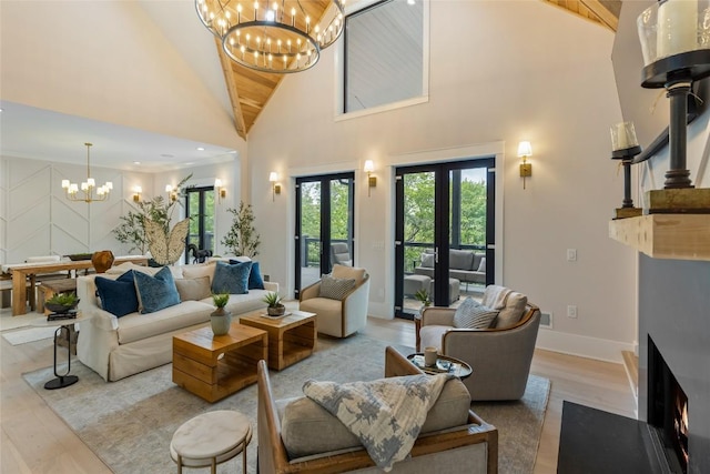 227 Sherwood Forest Rd, Highlands, NC 28741 - living room with a chandelier, high vaulted ceiling, light wood finished floors, and baseboards