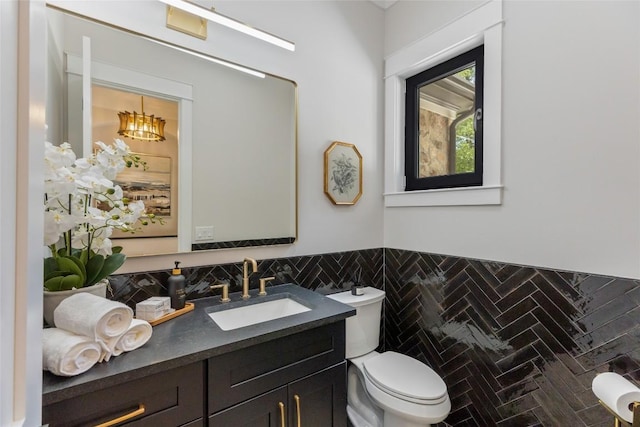 227 Sherwood Forest Rd, Highlands, NC 28741 - half bathroom with toilet, vanity, tile walls, and a wainscoted wall