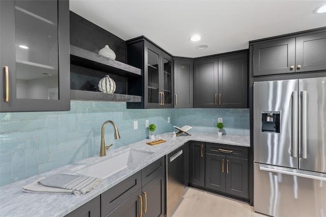 227 Sherwood Forest Rd, Highlands, NC 28741 - kitchen featuring appliances with stainless steel finishes, a sink, light stone counters, and tasteful backsplash