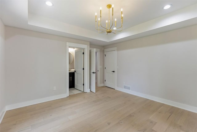 227 Sherwood Forest Rd, Highlands, NC 28741 - unfurnished room featuring a raised ceiling, a chandelier, baseboards, light wood-style flooring, and recessed lighting