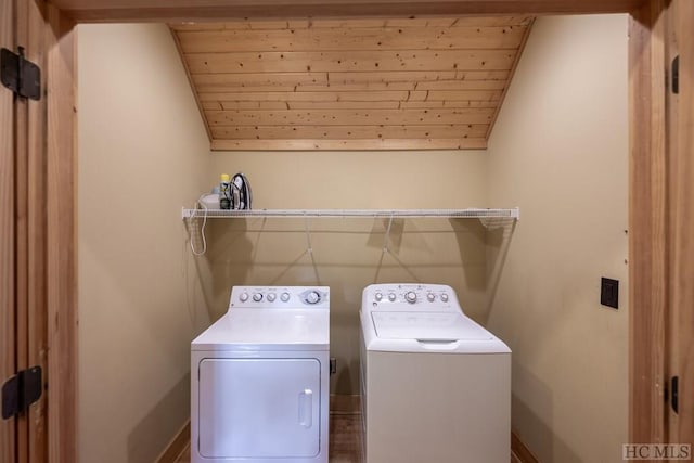 laundry room featuring wooden ceiling and washer and dryer