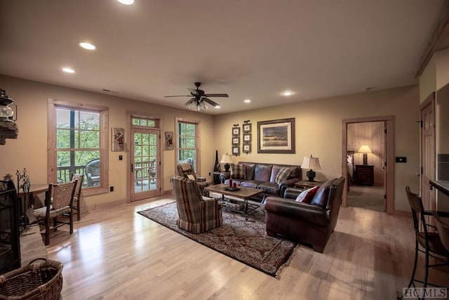 living room with light hardwood / wood-style floors and ceiling fan