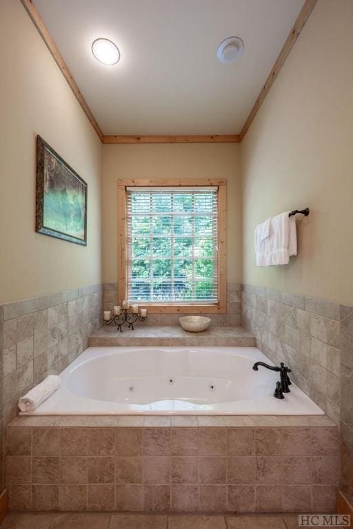 bathroom with tiled bath and crown molding