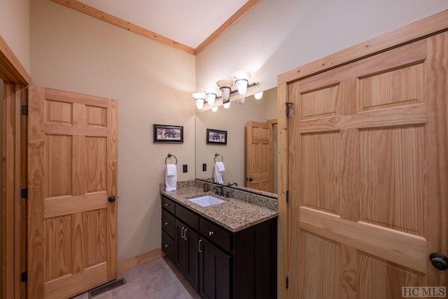 bathroom featuring ornamental molding, tile patterned flooring, and vanity