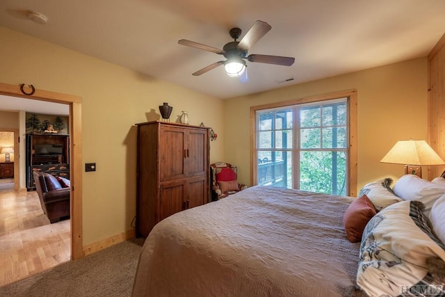 bedroom with ceiling fan and light colored carpet