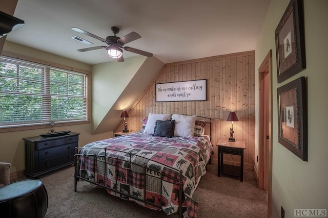 bedroom featuring ceiling fan, carpet floors, and wooden walls