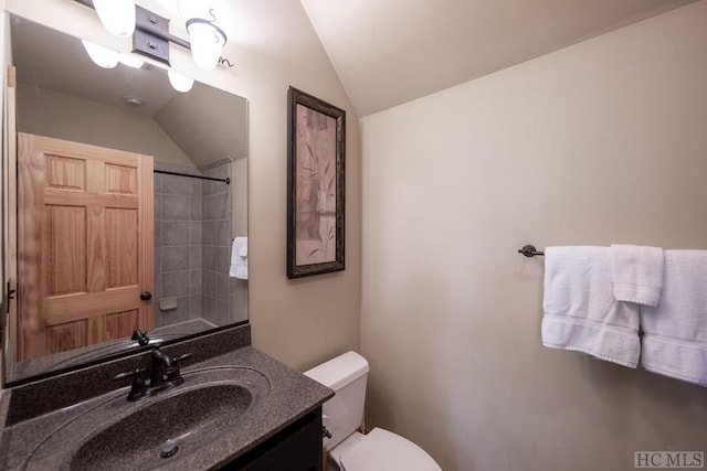 bathroom with vanity, toilet, and lofted ceiling