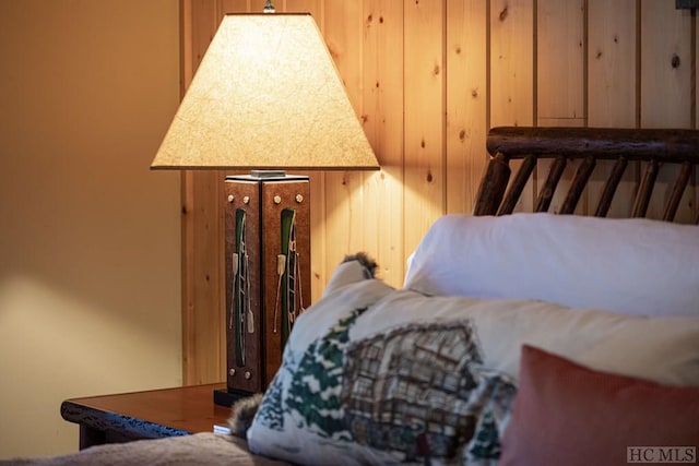 bedroom featuring wooden walls