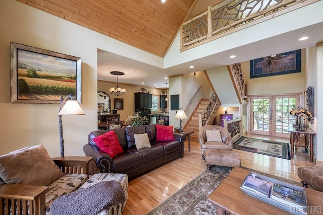 living room with wood ceiling, light hardwood / wood-style flooring, high vaulted ceiling, and an inviting chandelier