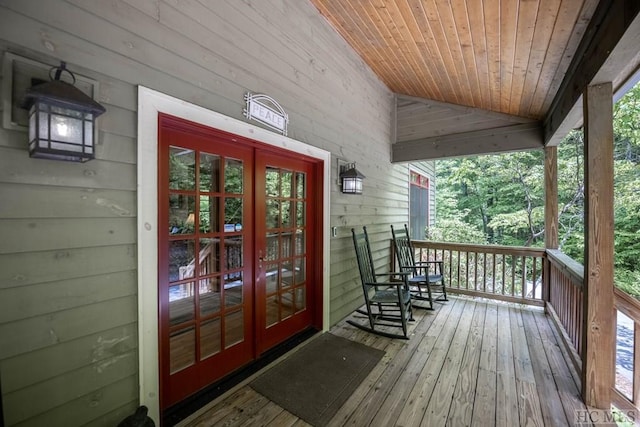 wooden terrace with french doors and a porch