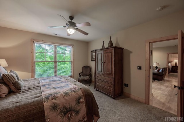 bedroom featuring light carpet and ceiling fan