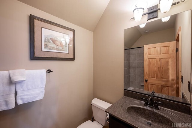 bathroom featuring vanity, vaulted ceiling, and toilet