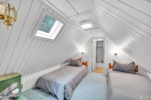 bedroom with lofted ceiling with skylight and light colored carpet