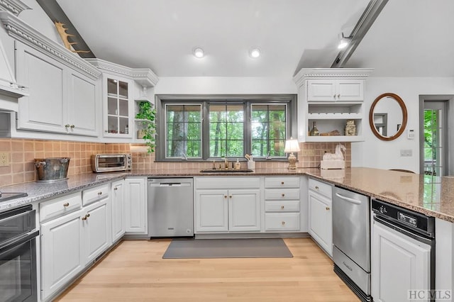 kitchen with white cabinets, oven, and dishwasher