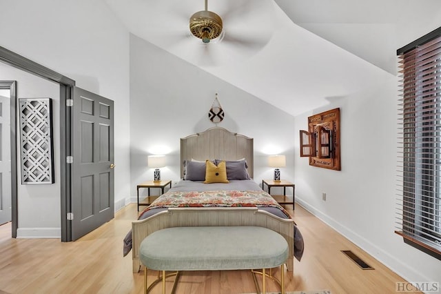 bedroom featuring ceiling fan, light hardwood / wood-style floors, and lofted ceiling