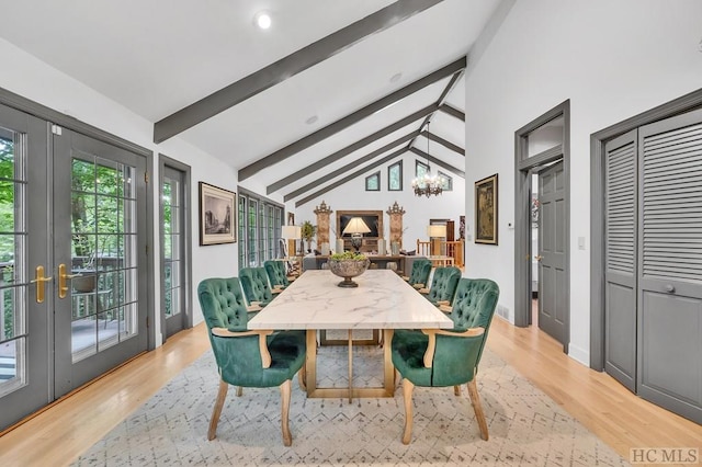 dining room with light wood-type flooring, vaulted ceiling with beams, an inviting chandelier, and french doors