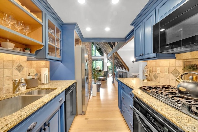 kitchen with blue cabinetry, light stone countertops, black appliances, and ornamental molding