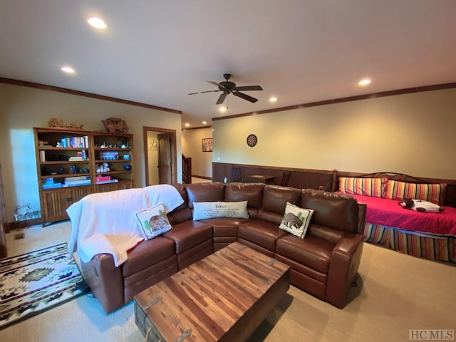 living room with light carpet, ornamental molding, and ceiling fan