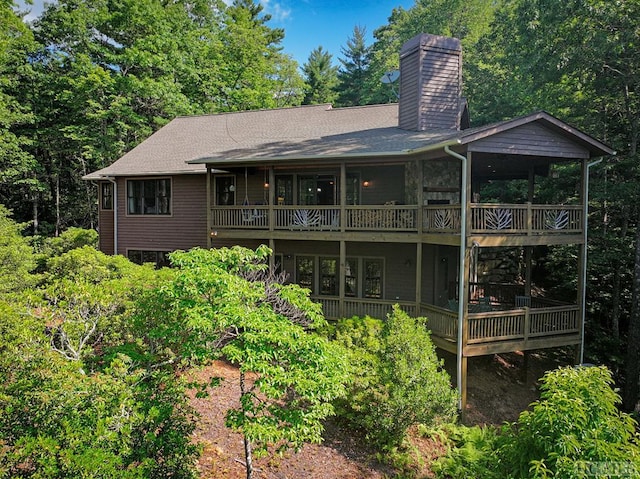 back of house featuring a balcony