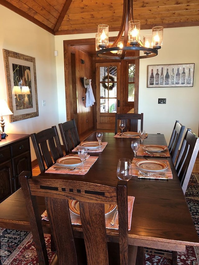 dining area featuring vaulted ceiling, a notable chandelier, and wood ceiling