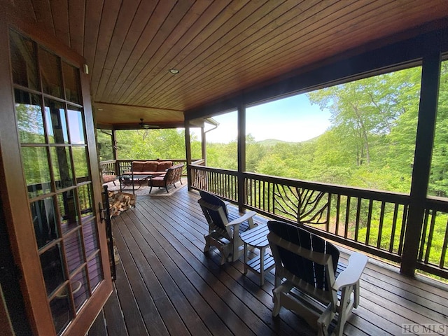 wooden deck featuring an outdoor hangout area and ceiling fan