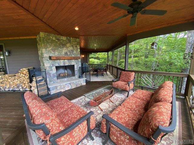 deck featuring an outdoor living space with a fireplace and ceiling fan