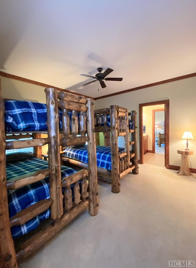 carpeted bedroom with ornamental molding and ceiling fan