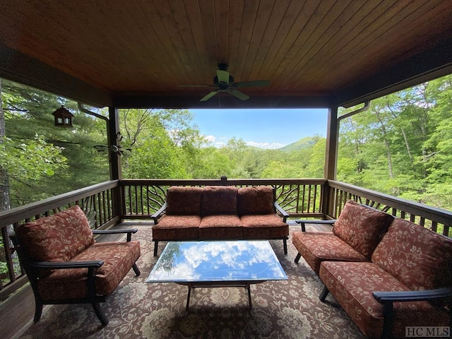 wooden deck featuring an outdoor hangout area and ceiling fan