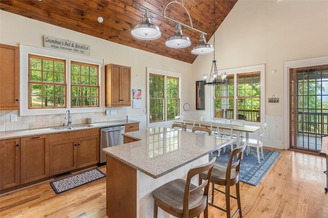50 Bluestar Way, Glenville, NC 28736 - kitchen with dishwasher, wood ceiling, brown cabinets, light wood-type flooring, and light stone countertops
