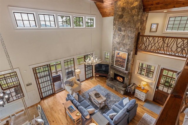 50 Bluestar Way, Glenville, NC 28736 - living room with high vaulted ceiling, a stone fireplace, wood finished floors, a chandelier, and wooden ceiling
