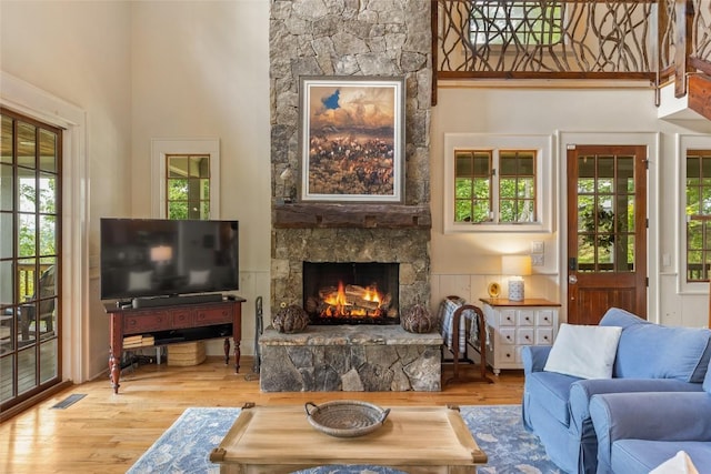 50 Bluestar Way, Glenville, NC 28736 - living room featuring a fireplace, wood finished floors, and a high ceiling
