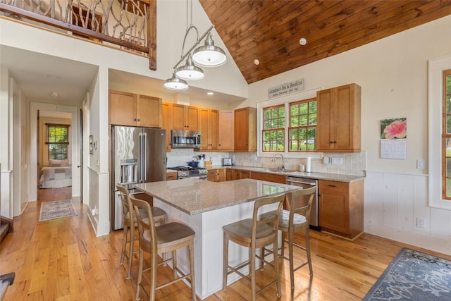 50 Bluestar Way, Glenville, NC 28736 - kitchen with high end appliances, light wood finished floors, light stone countertops, a kitchen bar, and a center island