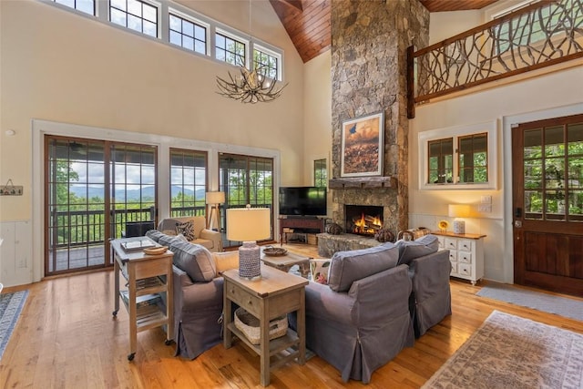 50 Bluestar Way, Glenville, NC 28736 - living area with high vaulted ceiling, wooden ceiling, plenty of natural light, light wood-type flooring, and a stone fireplace