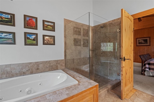 bathroom with a stall shower, a whirlpool tub, and ensuite bathroom
