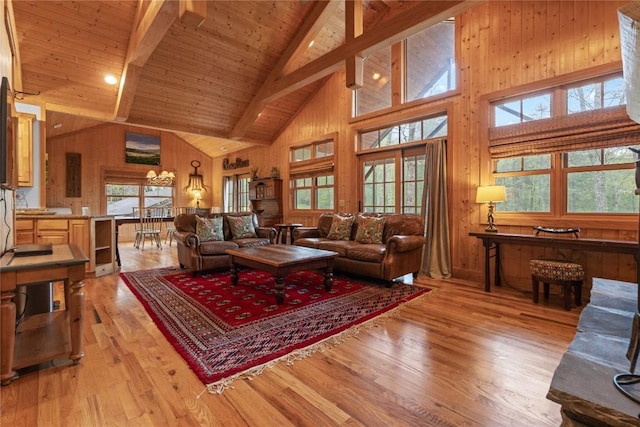 living room with high vaulted ceiling, beam ceiling, healthy amount of natural light, light wood-type flooring, and wood ceiling