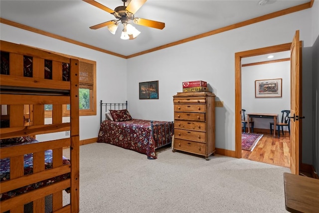 bedroom featuring ornamental molding, carpet floors, baseboards, and a ceiling fan