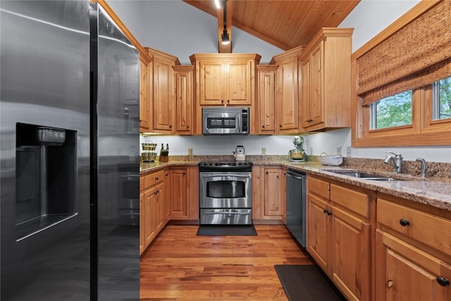 kitchen with stainless steel appliances, light wood finished floors, a sink, wooden ceiling, and light stone countertops
