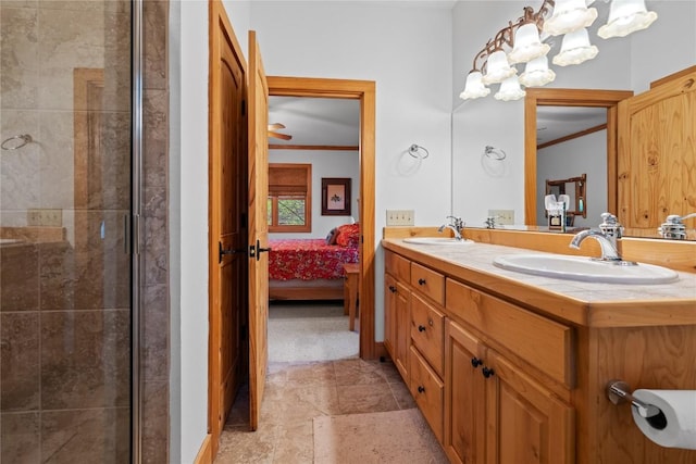 bathroom with ensuite bathroom, ornamental molding, tiled shower, stone finish flooring, and double vanity