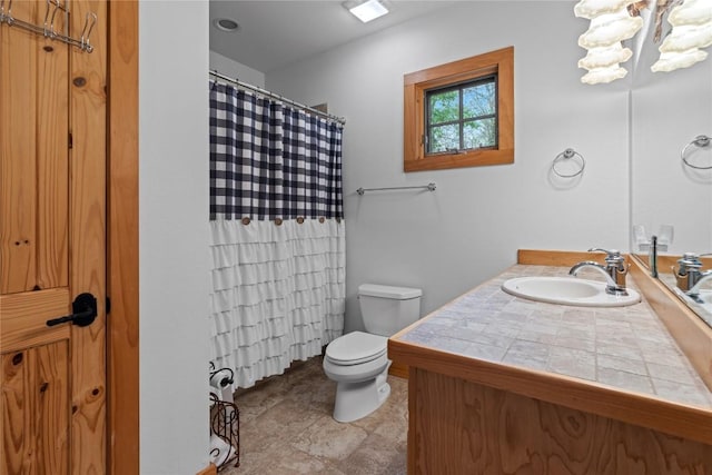 bathroom with toilet, vanity, and a shower with shower curtain