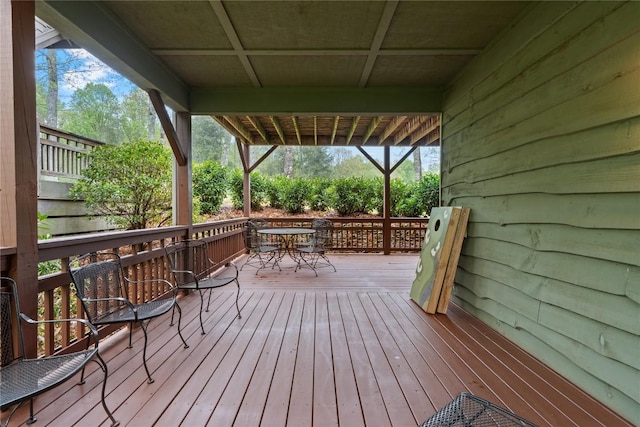 wooden terrace with outdoor dining area