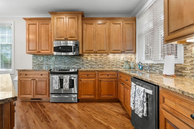 410C Highlands Cove Dr Unit 1300C, Highlands, NC 28741 - kitchen featuring stainless steel appliances, ornamental molding, light wood finished floors, light stone counters, and backsplash