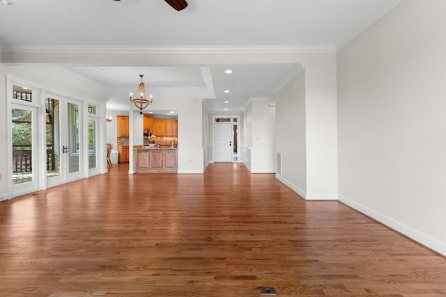 410C Highlands Cove Dr Unit 1300C, Highlands, NC 28741 - unfurnished living room featuring wood finished floors, a chandelier, recessed lighting, ornamental molding, and a ceiling fan