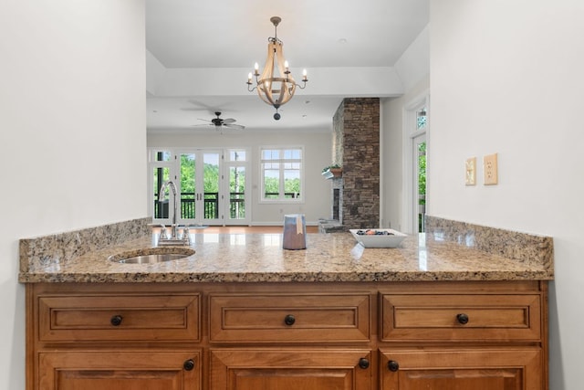 410C Highlands Cove Dr Unit 1300C, Highlands, NC 28741 - kitchen featuring brown cabinetry, a peninsula, light stone counters, and a ceiling fan