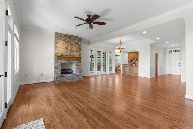 410C Highlands Cove Dr Unit 1300C, Highlands, NC 28741 - unfurnished living room featuring a stone fireplace, ceiling fan, a chandelier, light wood-style flooring, and crown molding